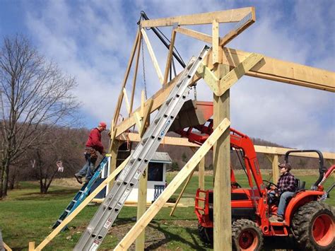 setting trusses with a skid steer|raising trusses for farm tractors.